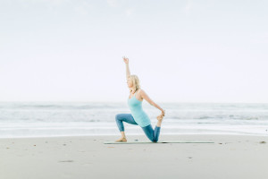 Melanee doing yoga on a beach in Santa Barbara