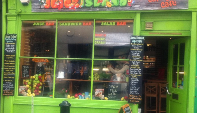 A juice bar in London with the menu written on the window