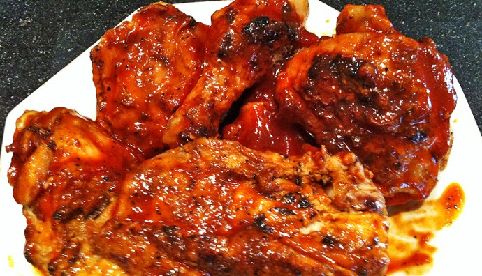 Grilled chicken covered in red sauce