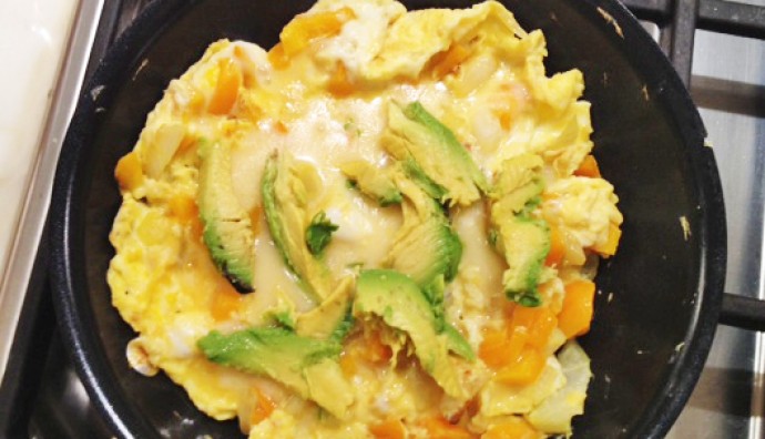 California omelette with avocado on top in a pan