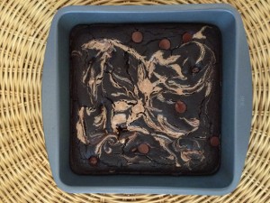Cooked chocolate and nut butter brownies in a grey pan