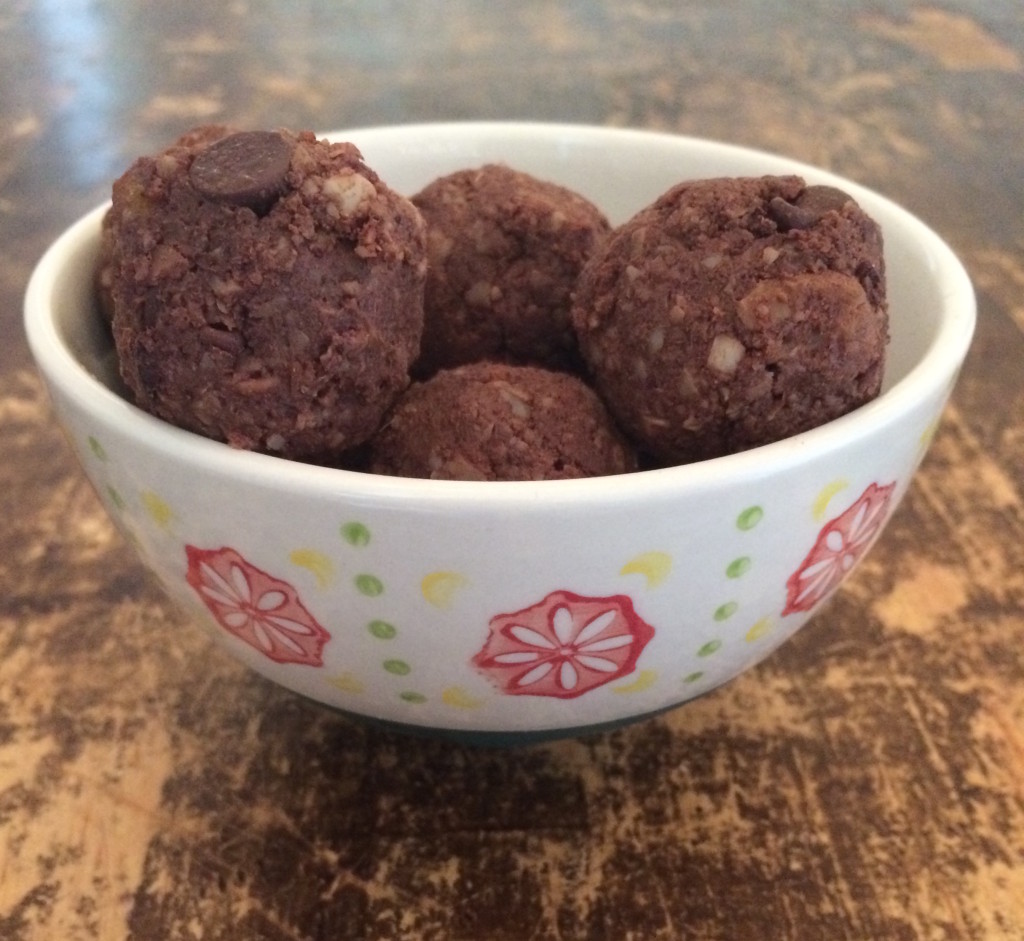 Cashew brownie balls in a small white bowl