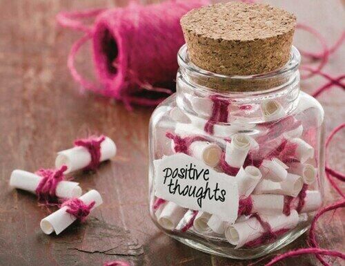 Little pieces of rolled paper in a positive thoughts jar