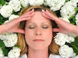 A woman's face surrounded by white flowers