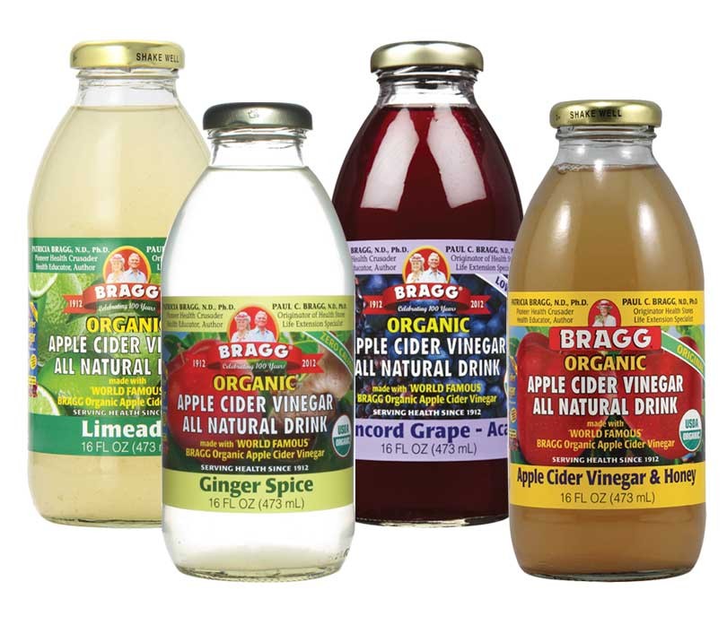 Four labeled bottles of organic apple cider vinegar