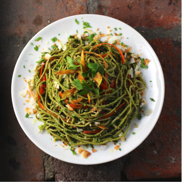 A plate with a big portion of green Edamame spaghetti