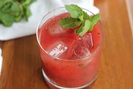 A glass of iced watermelon juice with mint on top