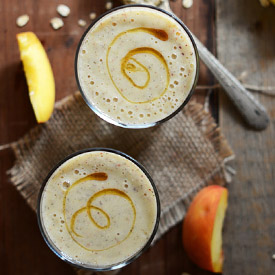Two glasses of vegan peach and oat smoothie